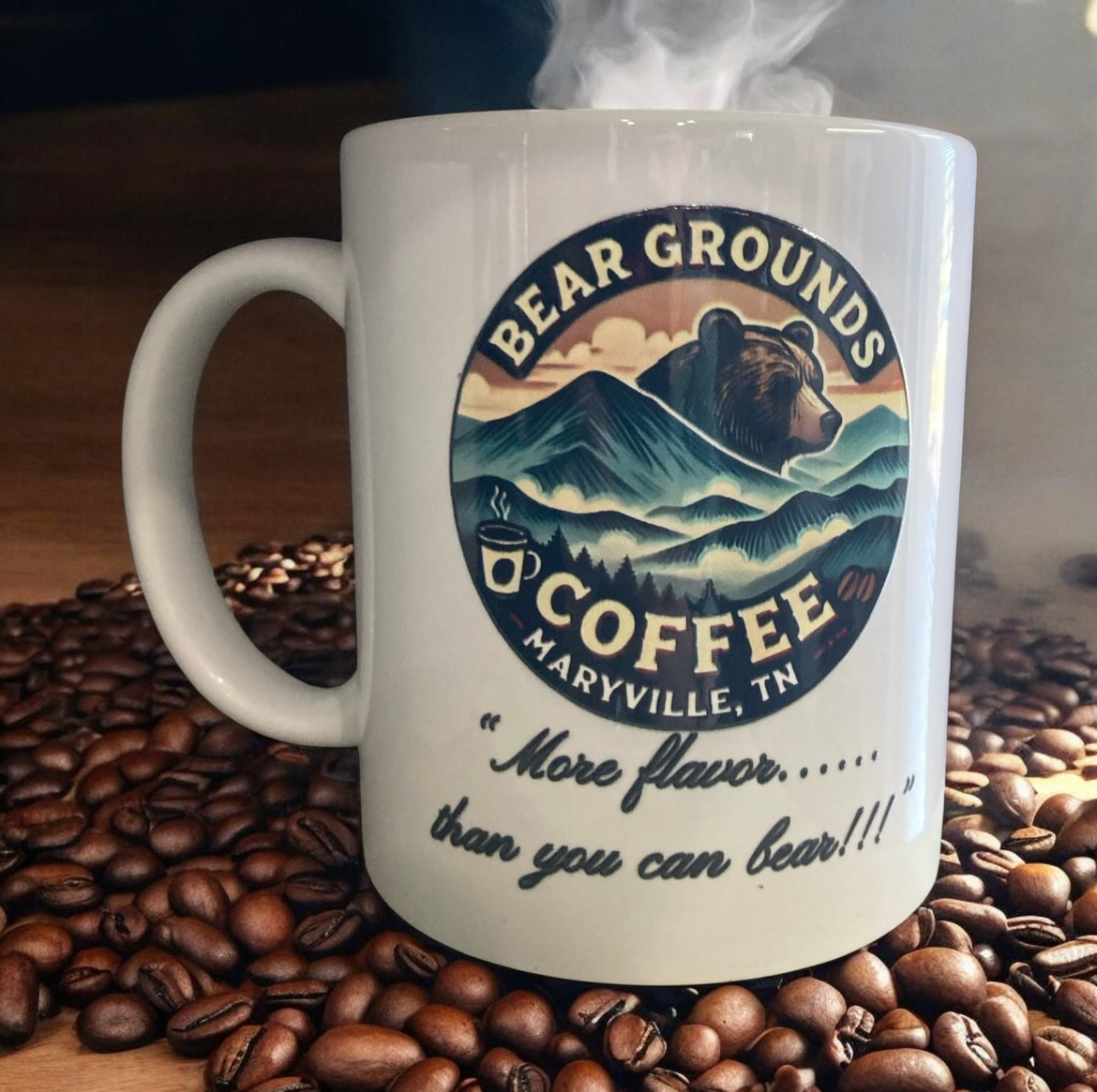 Bear Grounds mug displayed on coffee beans